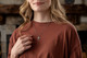 Shields Of Strength Be Still And Know Cross Necklace - Psalm 46:10. Woman wearing the cross necklace