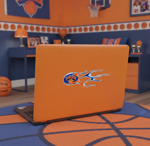 New York Knicks NBA Flame Emblem Decal Set - 2‑Piece UV‑Protected Flame Graphics - Displayed on the back of a laptop in a blue and orange basketball themed room