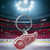 Detroit Red Wings Hockey Rubber Logo Keychain on a ice hockey rink background