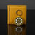Boston Bruins Hockey Rubber B Logo Keychain - Displayed on a black table next to a yellow gold color wallet