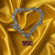 USC Trojans NCAA Logo Charm Chain Bracelet - Displayed on a gold color fabric background