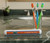 Florida Gators Toothbrush Case - Displayed on a bathroom counter top next to orange, blue and green toothbrushes.