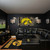 Iowa Hawkeyes NCAA 3' x 5' Realtree Camo Flag - Indoors - Hanging on a wall above a black couch in a sports fan cave