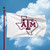 Texas A&M Aggies NCAA 3' x 5' White State Logo Flag - Flying outdoors on a flag pole with the blue sky in the background
