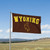 Wyoming Cowboys Collegiate Wordmark Logo Flag On a Flag Pole.