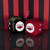 University Of Arkansas NCAA Plush Toy Fuzzy Dice - Displayed on a black table in front of a black and red striped wall