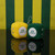 Oregon Ducks NCAA Plush Fuzzy Logo Dice – Green & Yellow 3" Hanging Team Dice Set - Displayed on a black table.