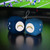 Los Angeles Chargers NFL Plush Fuzzy Dice Danglers - on a glossy black table with a football game on the tv in background