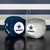 Dallas Cowboys NFL Plush Fuzzy Dice - On a black table in front of a cowboys navy blue and silver color striped wall