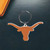 UT - Texas Longhorns Collegiate Rubber Logo Flex Keychain - Displayed on a black table next to an burnt orange wallet