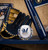 Milwaukee Brewers MLB Digital Camo Soft Strike Baseball - Displayed on a blue shelf next to a baseball bat and glove.