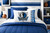 Dallas Mavericks pillowcase standard size with logo and side text stripe displayed on bed in blue and white basketball themed room decor