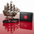Tampa Bay Buccaneers Football Lanyard Wristlet Keychain - Displayed on a red table next to a black wallet and a miniature pirate ship in the background