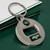 New York Jets NFL Round Bottle Opener Keychain - On a Green Table next to a white wallet