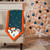 Miami Dolphins Holiday Applique Snowman Table Runner - Displayed as a throw over a chair next to a Christmas tree
