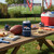 Denver Broncos Football Can Cooler - Displayed outdoors on a picnic table
