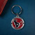 Houston Texans NFL Round Metal Logo & Wordmark Keychain - On a Texans Blue Table next to a wallet