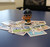 Seattle Mariners MLB 1" Mini Toy Pitcher Figure - On an office desk next to baseball cards
