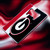Georgia Bulldogs Slim Metal Logo Bottle Opener Magnet - Displayed on a team color gradient background