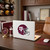 Texas A&M Aggies NCAA Football Helmet Decal - Displayed on the back of a laptop in a football themed office