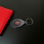 San Francisco 49ers Metal Football Textured Keychain - Displayed on a black table next to a red wallet