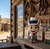 Dallas Cowboys Mascot Figure Rowdy - Displayed standing on a rustic wooden shelf outside an old western general store.