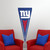 New York Giants NFL Football Vertical Logo Pennant - Indoors hanging on a wall between two red chairs