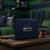 Seattle Seahawks logo decal on a navy blue laptop in a themed sports fan cave with blue and green decor, Dragon Sports
