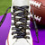 Baltimore Ravens NFL Football Black Wordmark Logo Shoe Laces - displayed on a purple background next to a football.