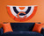 Chicago Bears NFL Football Embroidered Logo Bunting Banner Flag - Indoors - Hanging on a Bears Orange Color wall, above a Navy couch with orange pillows