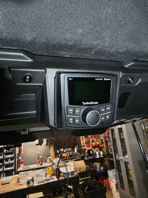 MarqCad Can-Am Defender HD11 stereo upgrade kit with head unit, amplifier, and subwoofer components installed in UTV