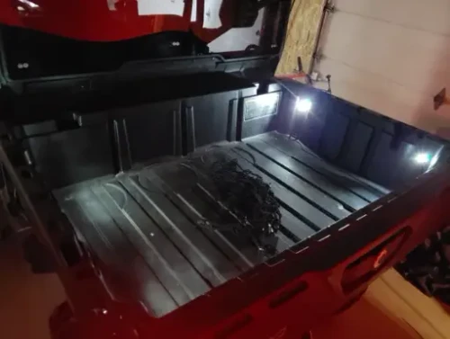 MCE Can-Am Defender Rear Bed Light Kit with flush-mount LED cargo box lights, plug-and-play wiring harness, and OEM-style connectors installed inside a Defender cargo bed.
