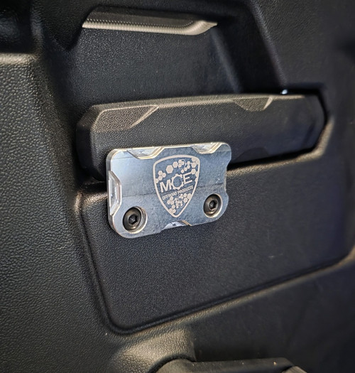 MCE Can-Am Defender rear door child lock bracket made from billet aluminum to prevent accidental door openings and improve passenger safety on rear doors.