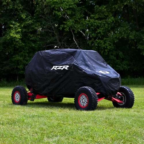 Polaris RZR Pro R 4, Pro R 4 Boost, Turbo R 4, and Pro XP 4 heavy-duty 300-denier vehicle storage cover with secure belly straps, integrated storage bag, and weather-resistant protection for 4-seat UTVs.