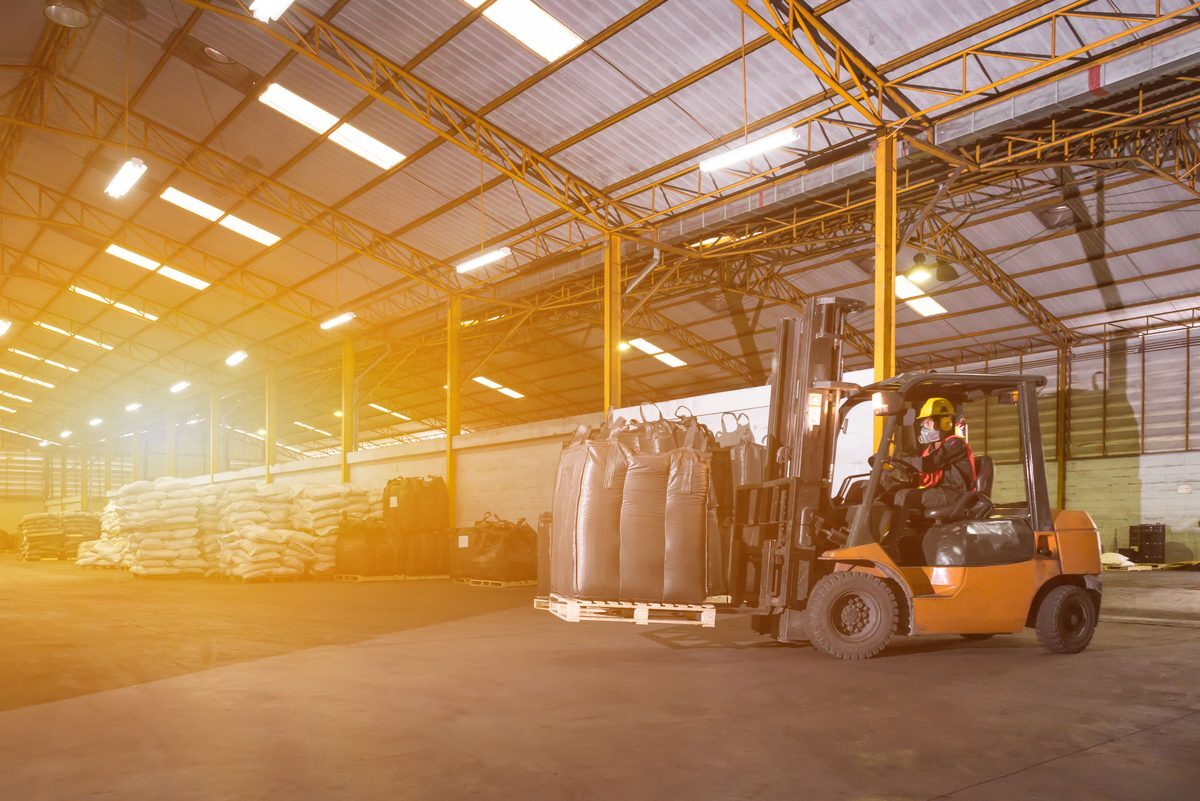 Counterbalance forklift on pneumatic tires moving palletized loads in a warehouse