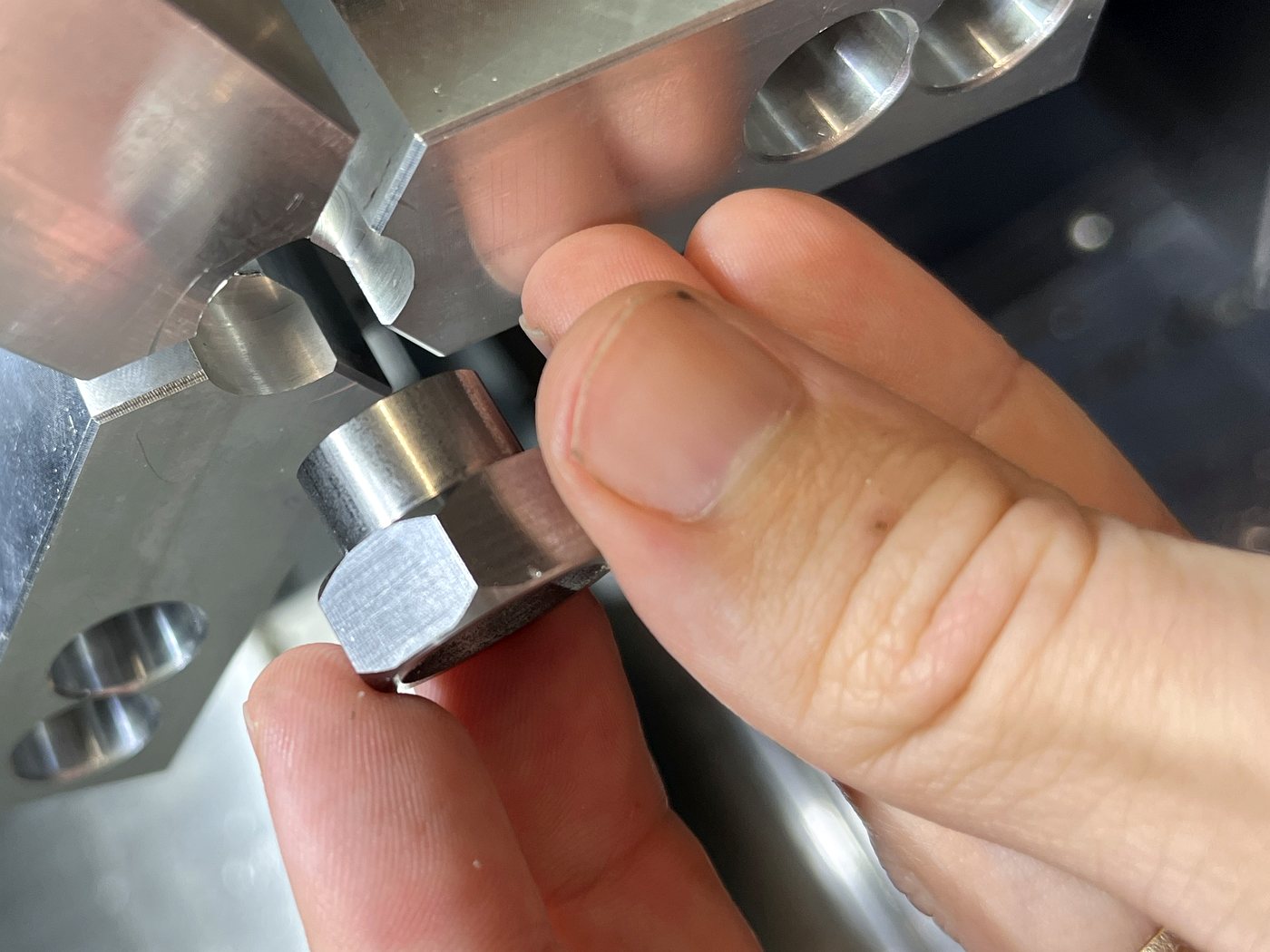 A finished part held beside the lathe chuck