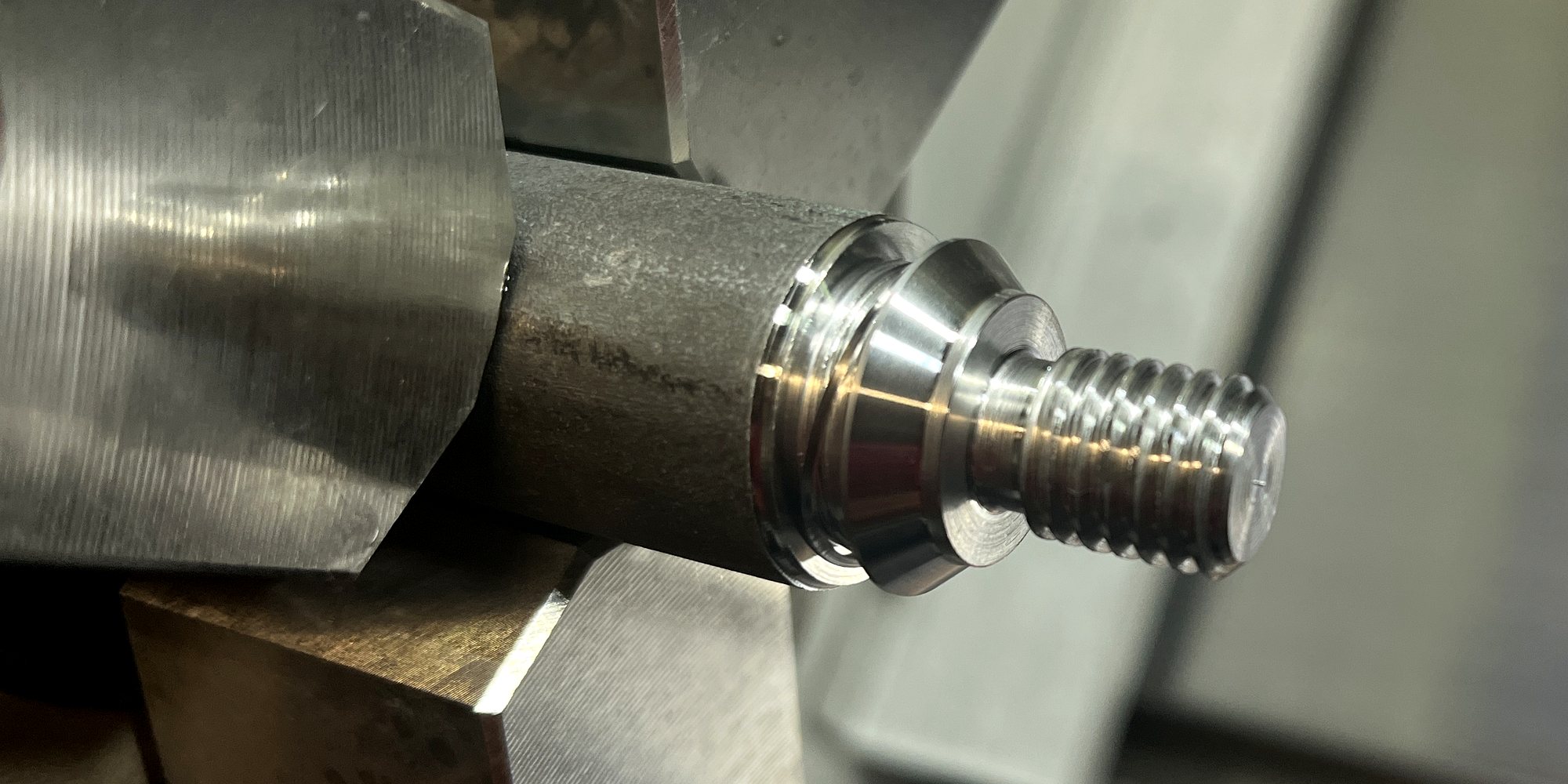 A threaded shoulder being turned in the lathe