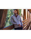 Man standing on a bridge while wearing Polished Heather Cutter & Buck Adapt Eco Knit Heather Mens Quarter Zip Pullover Thumbnail Image