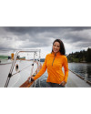 Woman standing next to a boat wearing a College Orange Cutter & Buck Adapt Eco Knit Stretch Recycled Womens Half Zip Pullover Thumbnail Image