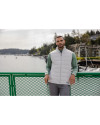 A man standing by water while wearing a Concrete Cutter & Buck Evoke Hybrid Eco Softshell Recycled Mens Full Zip Vest Thumbnail Image