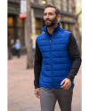 A man walking outside while wearing a Tour Blue Cutter & Buck Evoke Hybrid Eco Softshell Recycled Mens Full Zip Vest Thumbnail Image