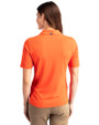 Back profile of a woman wearing a College Orange Cutter & Buck Virtue Eco Pique Recycled Womens Polo