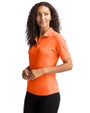 Side profile of a woman wearing an Orange Burst Cutter & Buck Virtue Eco Pique Recycled Womens Polo