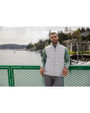 A man standing by water while wearing a Concrete Cutter & Buck Evoke Hybrid Eco Softshell Recycled Mens Full Zip Vest