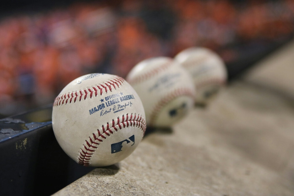 3 official MLB baseballs lined up.