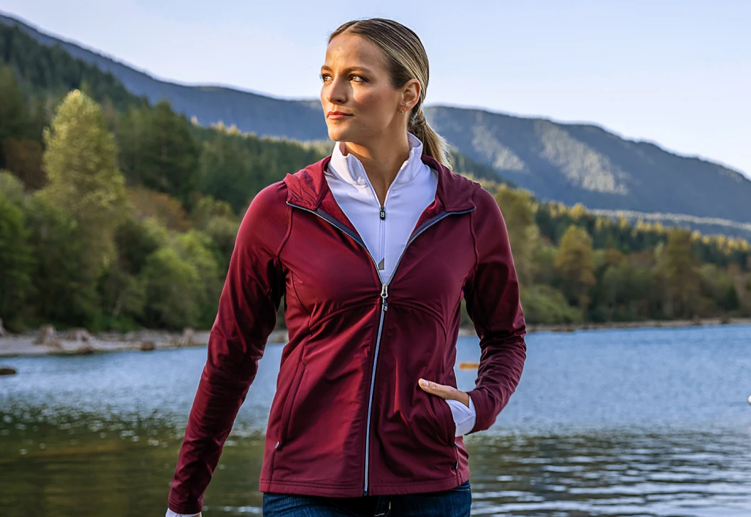 Woman wearing Cutter & Buck pullover layers to stay comfortable while hiking in winter