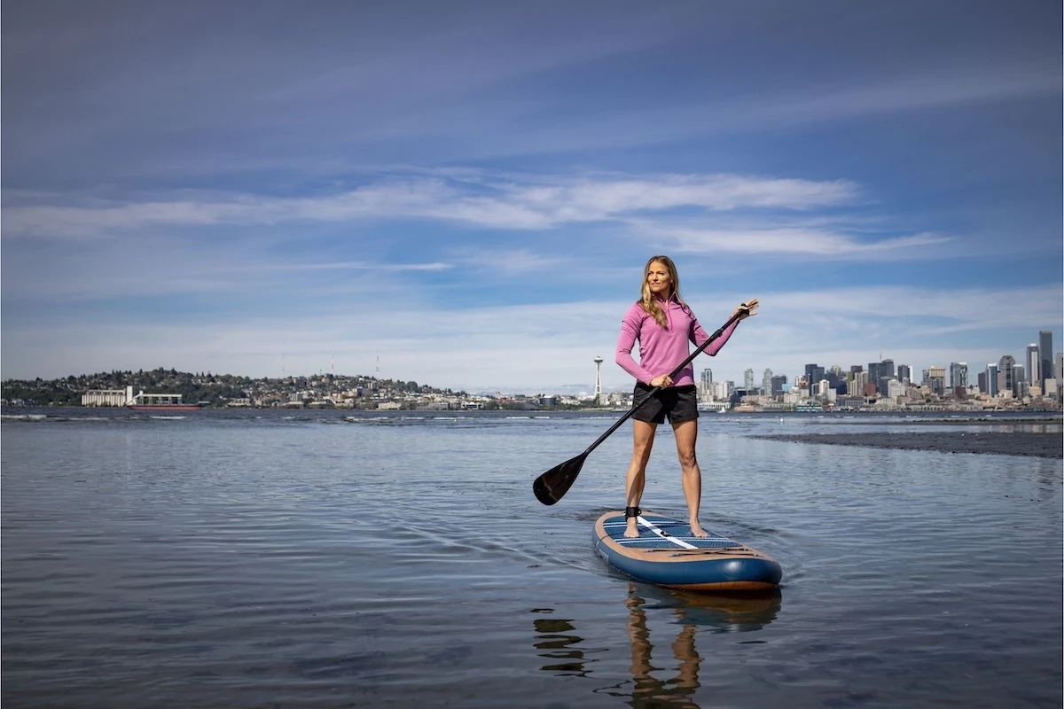 woman paddle boarding in river
