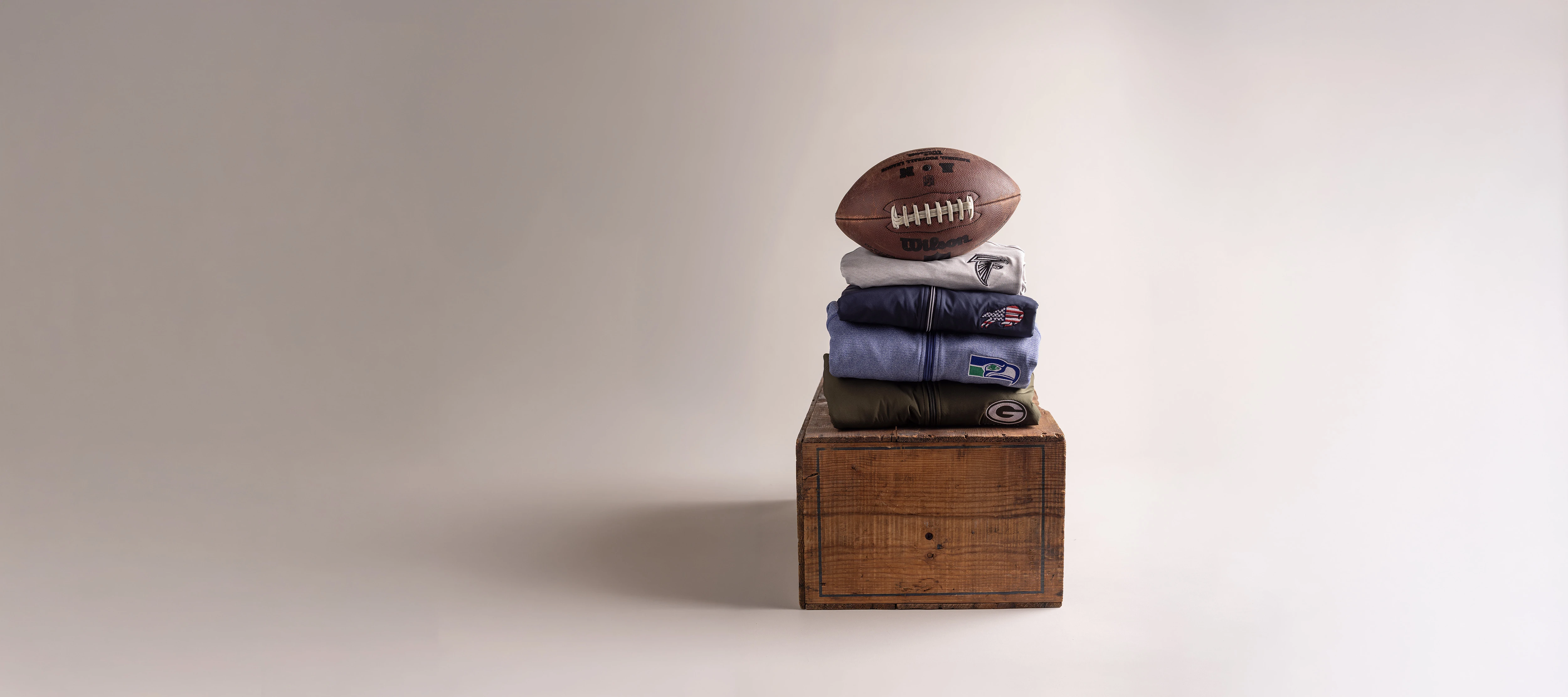 NFL branded clothing on wood block