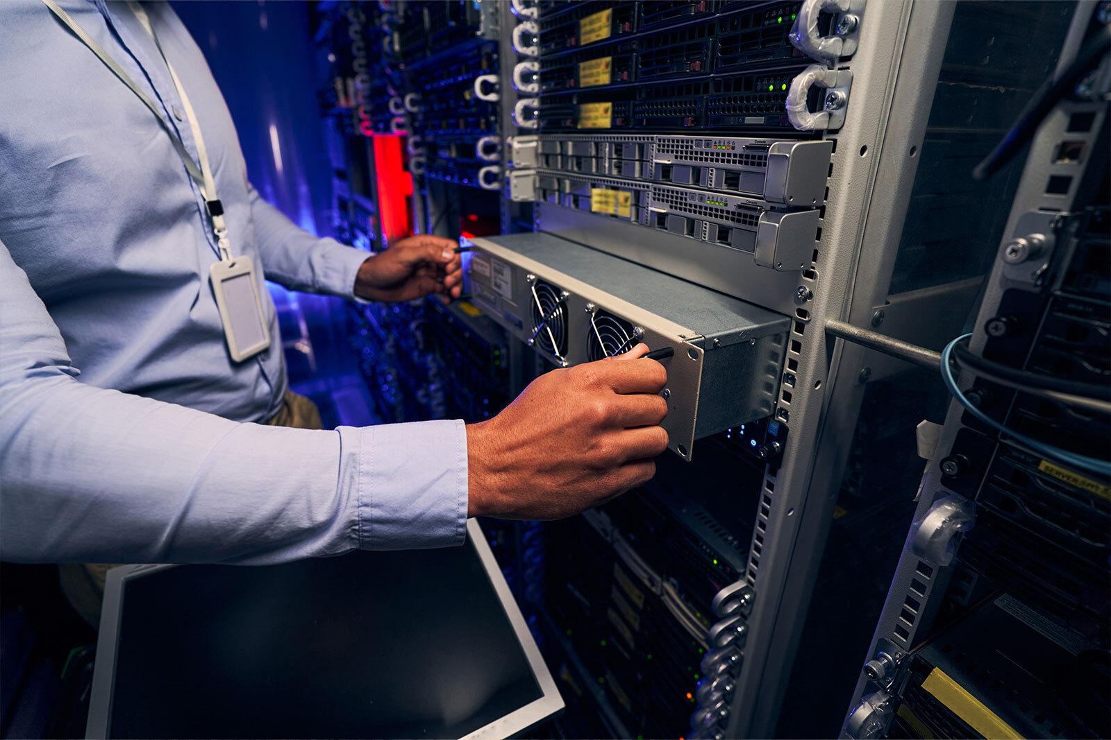 Colocation data center technician at rack