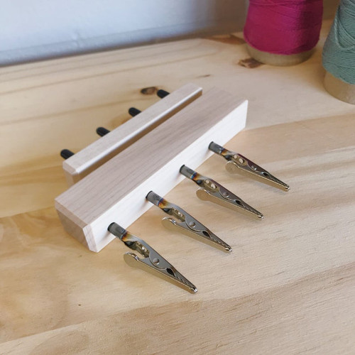 Handcrafted maple Quad End Fringe Twister tool for fiber artists, allowing fast and even twisting of four fringe bundles simultaneously.